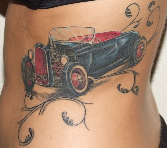 A Car with Creative Tribal Tattoo Designs for the Racer on the Lower Back of A Girl Racer