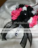   black accent flower. The stem is wrapped in black and white ribbon