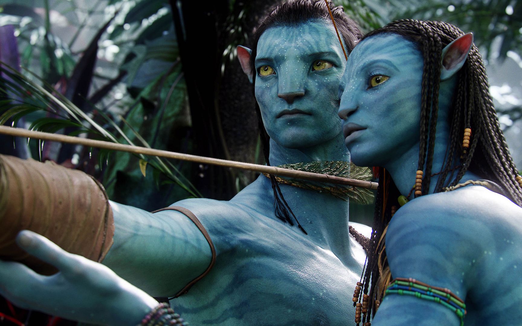 Neytiri teaches Jake how to shoot a bow and arrow, in a scene from Avatar. ©2009 20th Century Fox, all rights reserved.