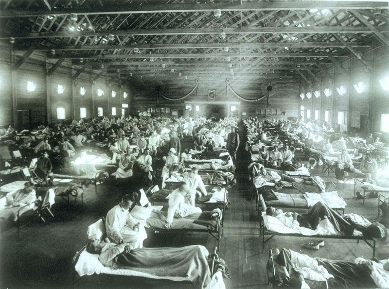 A now-iconic photograph from LIFE magazine of nurses tending to military patients at an emergency hospital in Camp Funston, Kansas during the Spanish Flu epidemic of 1918.