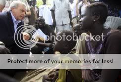 UN Undersecretary-Gen for Humanitarian Affairs John Holmes chats with women in war-torn Akobo, Sudan. Photo courtesy AFP.