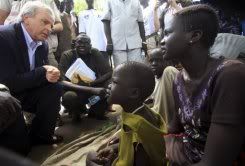 UN Undersecretary-Gen for Humanitarian Affairs John Holmes chats with women in war-torn Akobo, Sudan. Photo courtesy AFP.